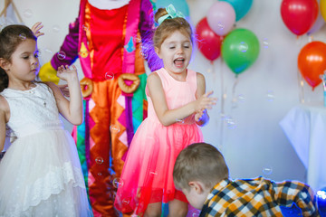 Children play with a clown
