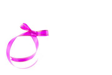 Pink ribbon with bow isolated on white background.