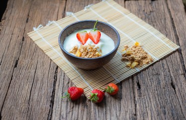 Top view strawberry yogurt and fresh strawberry on wooden white background.