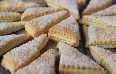 Homemade shortbread puff pastry Triangle on a wooden ancient rustic background. Side view. Place for text.