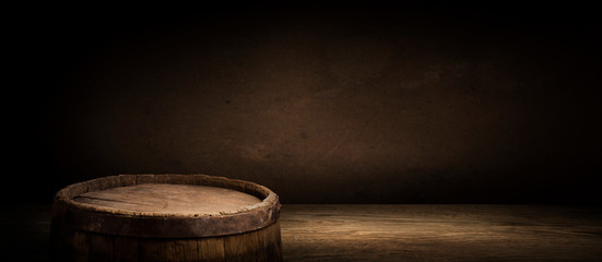 Wooden barrel on a table and textured background