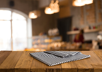 Empty brown wooden table and blur background of abstract of resturant lights people enjoy eating ,can be used for montage or display your products