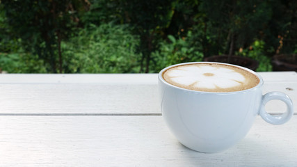a cup of latte art coffee on wooden background                                                                                                                                                          