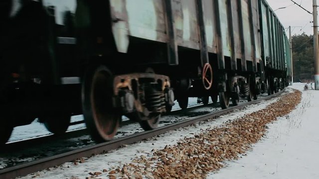 railway in winter the train passes on rails. Cloudy day train rides close up