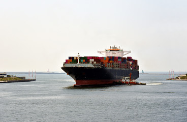 Cargo container ship arriving to the sea port in Kaohsiung, Taiwan.