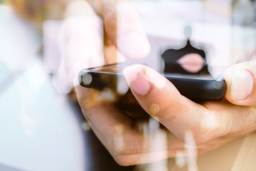 Hands with mobile, double exposure