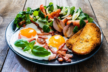 Continental breakfast - sunny side up eggs ,toasts and vegetable salad