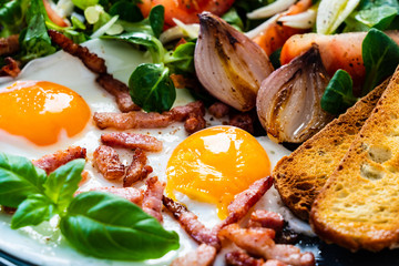 Continental breakfast - sunny side up eggs ,toasts and vegetable salad