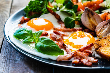 Continental breakfast - sunny side up eggs ,toasts and vegetable salad