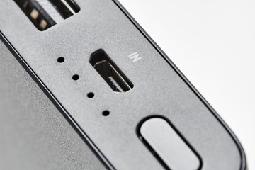 Control Panel of External powerbank with two usb outputs on a white background. Powerbank for charging mobile devices. Closeup, selective focus