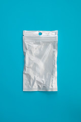 empty transparent plastic zip lock bag on blue background, ziplock for medicines