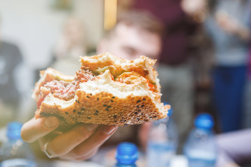 Eating a burger in a cafe