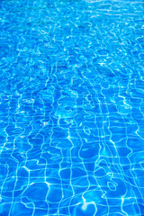Pure clear ripped blue swimming pool water background , vertical composition