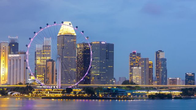 Time lapse of day to night of beautiful Singapore flyer and cityscape of Singapore.