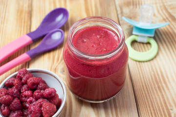 baby raspberry puree in a jar. baby food.