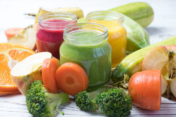 Assortment of jars with tasty baby food on wooden table. vegetable and fruit purees.