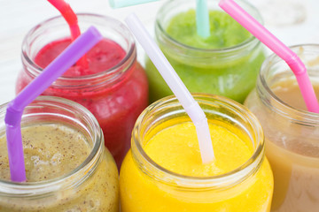 colorful baby purees in jars. cocktails with tubes in miniature, creative jars