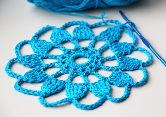 Needlework. Beautiful knitted blue napkin. Crochet.