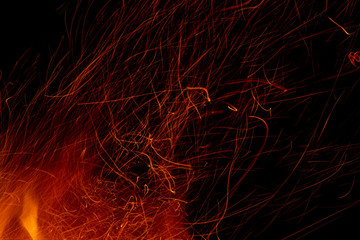 flame of fire with long sparks on a black background