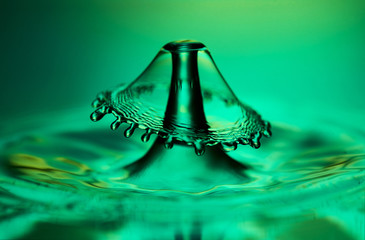 A close up photograph of a red water drop collision created when a water drop splashing up