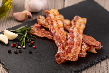 Closeup of slices of crispy hot fried bacon