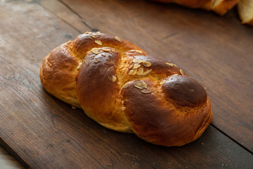 Sweet bread, easter greek tsoureki braid on wood background