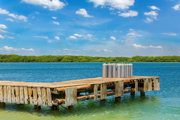 Group of oxygen tanks stands on jetty in sea
