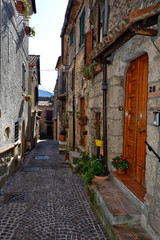 Fototapeta na wymiar Collepardo, Italy, 02/22/2020. An alley between the old stone houses of a medieval village.
