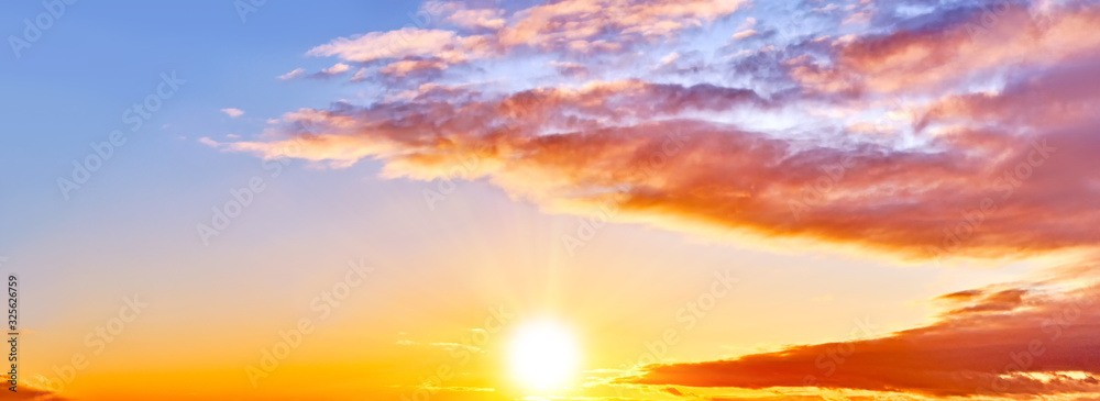 Wall mural sunset sky landscape background natural color of evening cloudscape with setting sun. orange clouds 