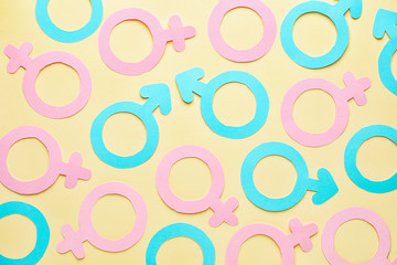 Many symbols of man and woman on color background. Concept of feminism