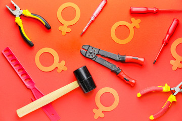 Tools with symbols on woman of color background. Concept of feminism