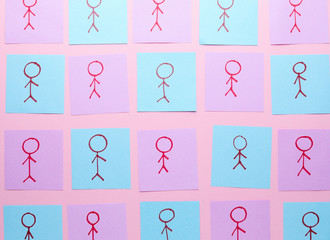 Many paper sheets with drawn human figures on color background. Concept of feminism