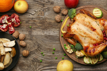 Tasty baked turkey and different food for Thanksgiving day on wooden table