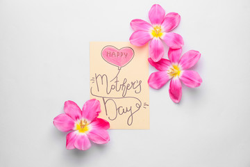 Beautiful flowers and card for Mother's Day on white background