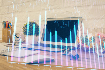 Financial graph colorful drawing and table with computer on background. Double exposure. Concept of international markets.