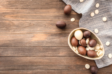 Fototapeta na wymiar Sweet chocolate Easter eggs on wooden background