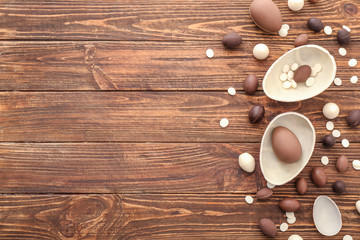 Sweet chocolate Easter eggs on wooden background