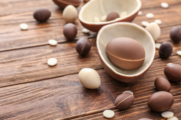 Sweet chocolate Easter eggs on wooden background