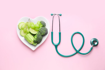 Plate with healthy products and stethoscope on color background - Powered by Adobe