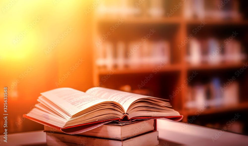 Poster stack of books in the library and blur bookshelf background