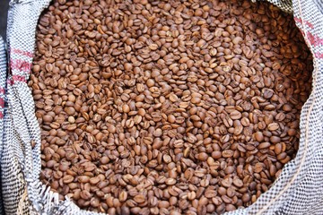 Raw coffee beans in sacks, coffee shop in Athens, Greece.