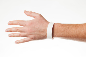 Hand with white wristband mockup. Empty ticket wrist band design. - obrazy, fototapety, plakaty