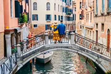 Poster paar staande op de brug over de grachten van Venetië © phpetrunina14