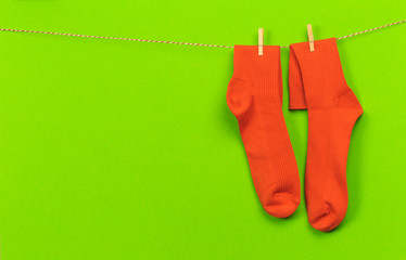 colorful   socks hanging on a rope on green   background - Image