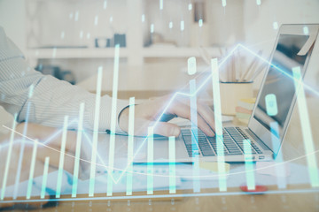 Multi exposure of stock market graph with man working on laptop on background. Concept of financial analysis.