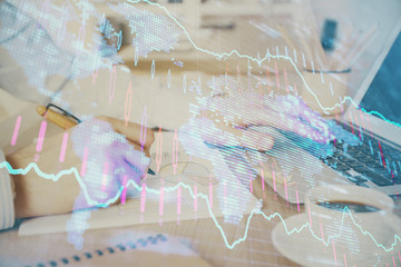 Multi exposure of stock market graph with man working on laptop on background. Concept of financial...