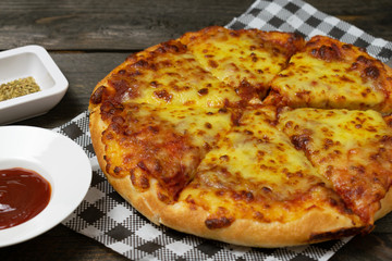 Pizza with Mozzarella cheese,Cheddar cheese on wooden background.