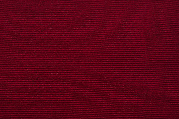 Texture of dark burgundy knitwear with silver thread,