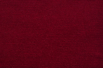 Texture of dark burgundy knitwear with silver thread,