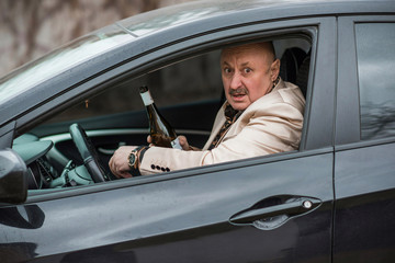 Mature man drink alcohol at car, social problem concept 